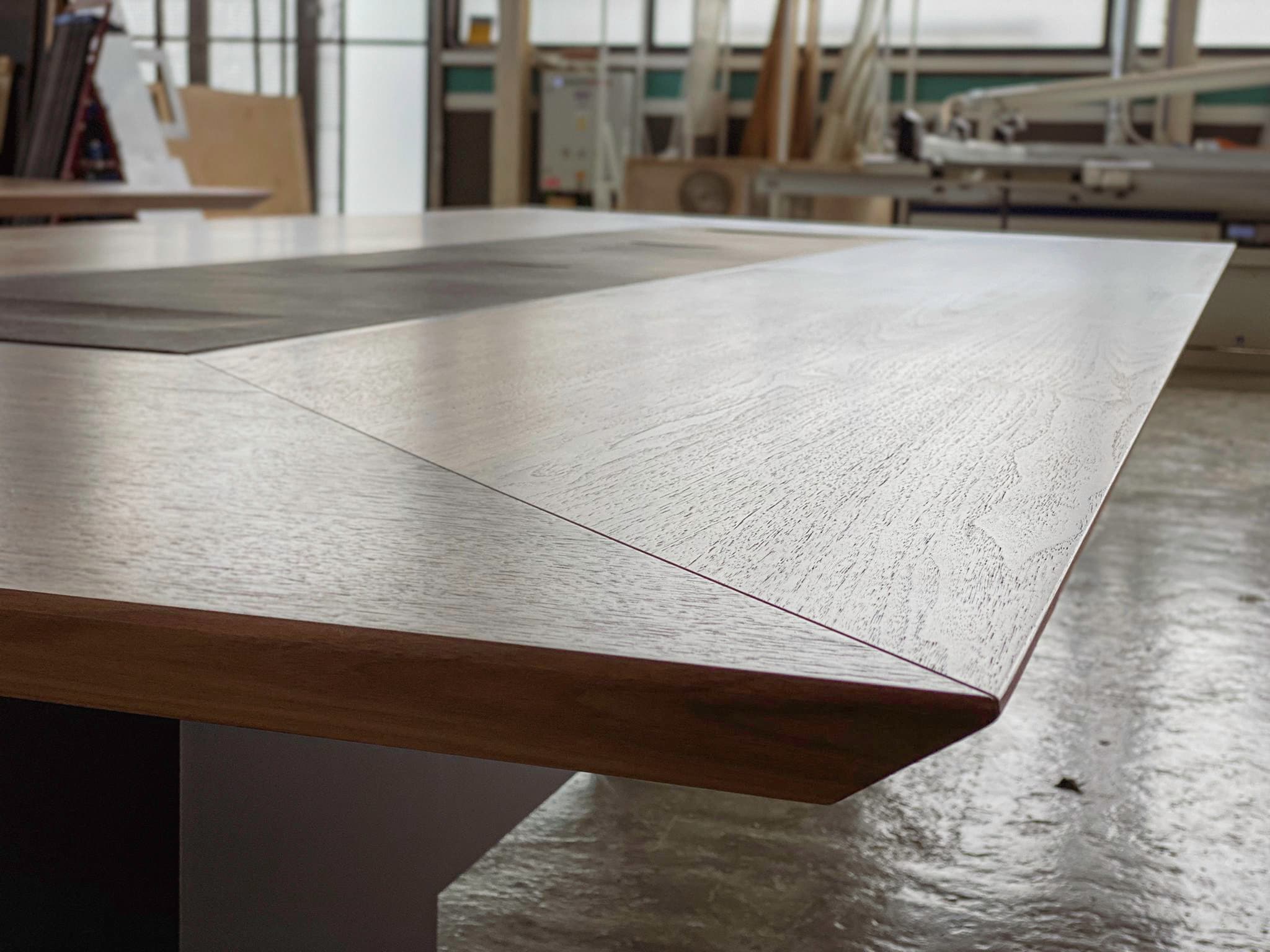 Close-up of a wood veneer tabletop with bevelled edge at the KZ Bespoke workshop