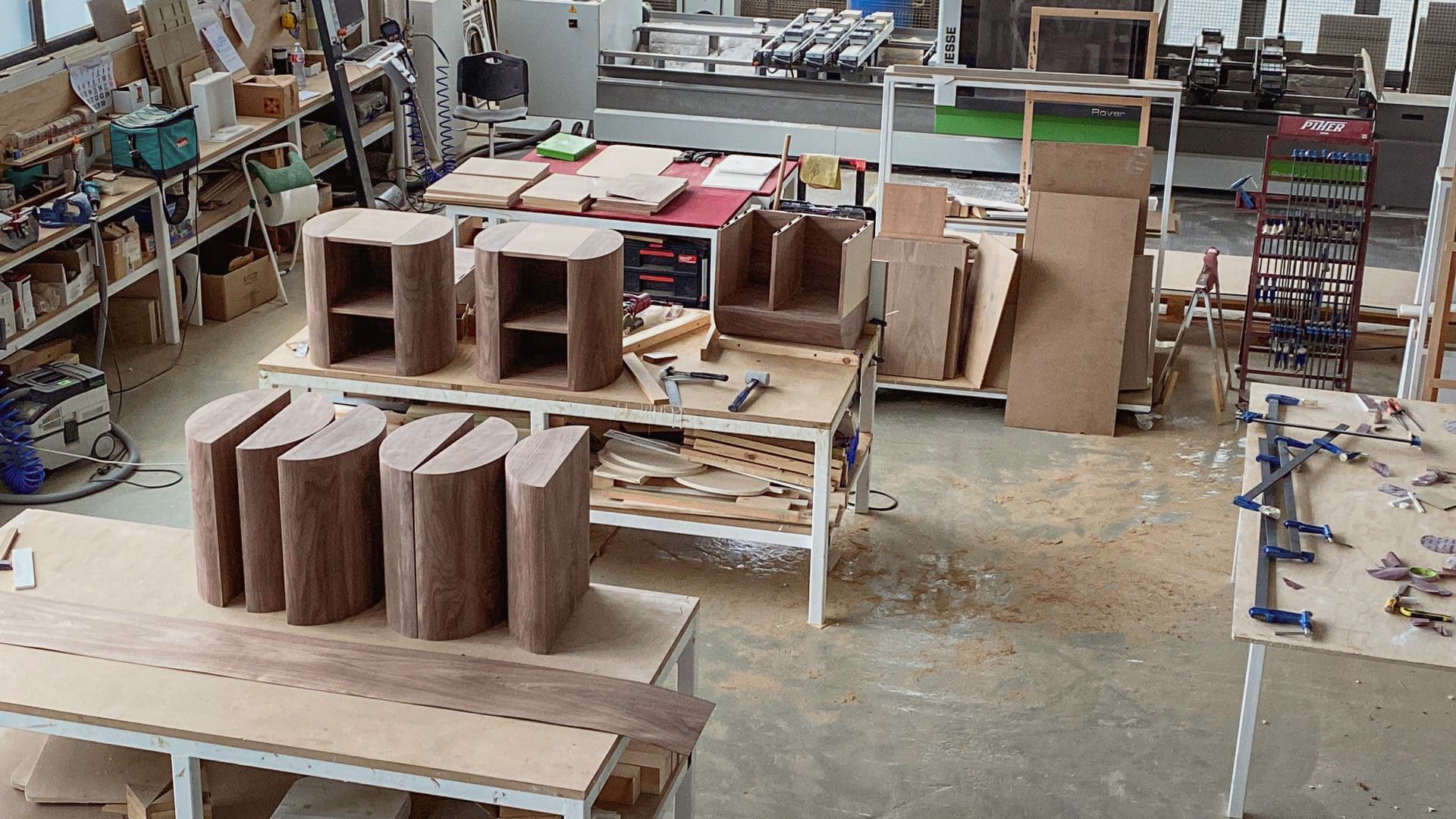 Walnut furniture pieces in production at the KZ Bespoke joinery workshop