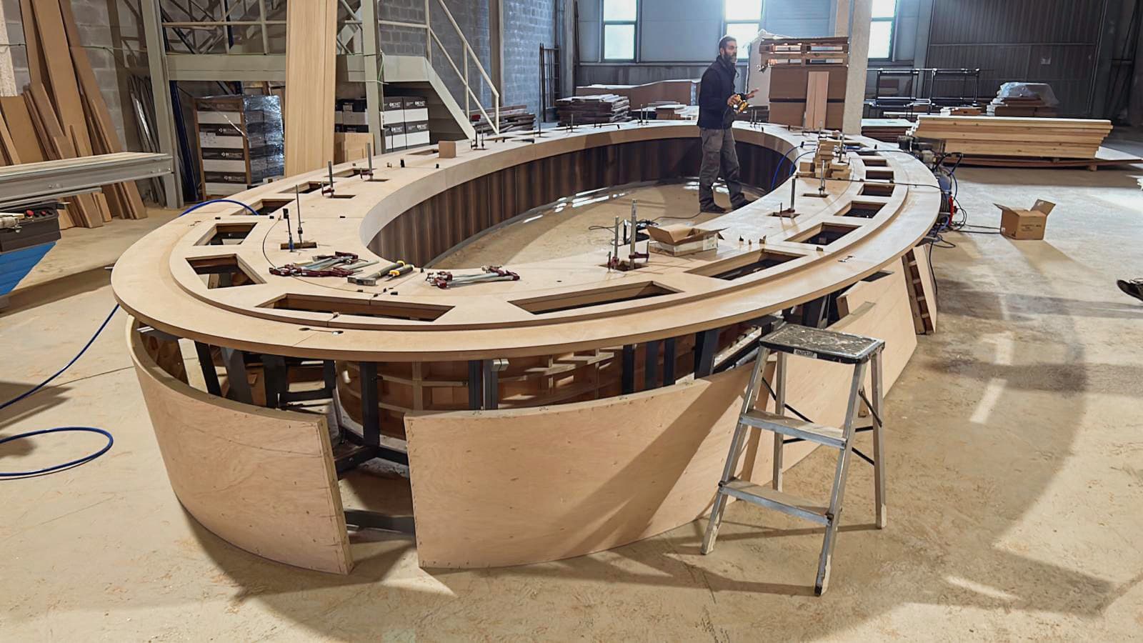 Large oval conference table structure under construction at the KZ Bespoke workshop